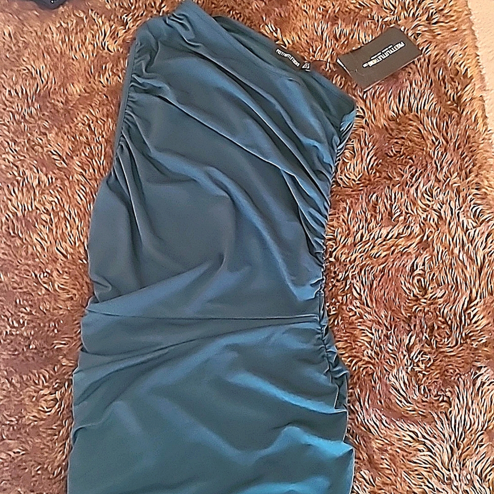 Green one shoulder dress.